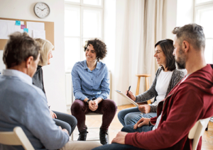 Folks sit and listen during intensive outpatient program
