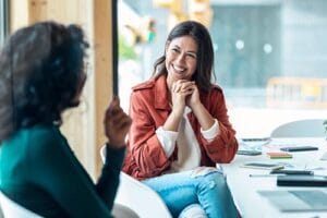Woman smiles while talking to therapist in women's eating disorder treatment